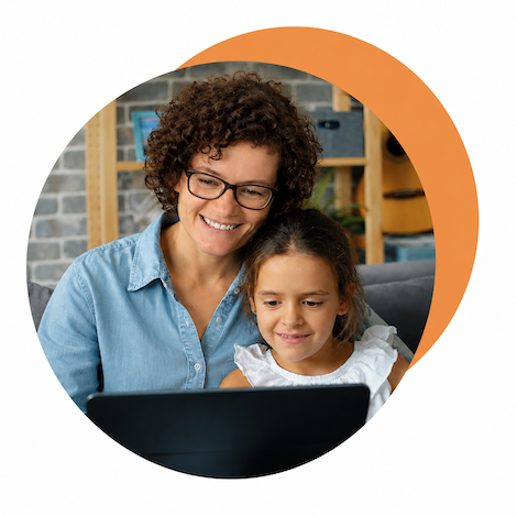 A mother and her daughter looking at a laptop together