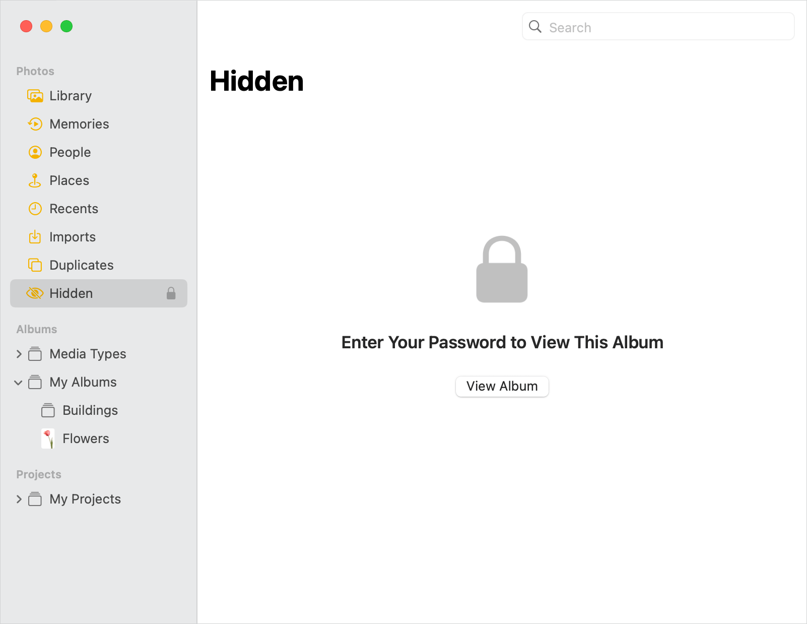 the Photos app window showing that the Hidden album is locked